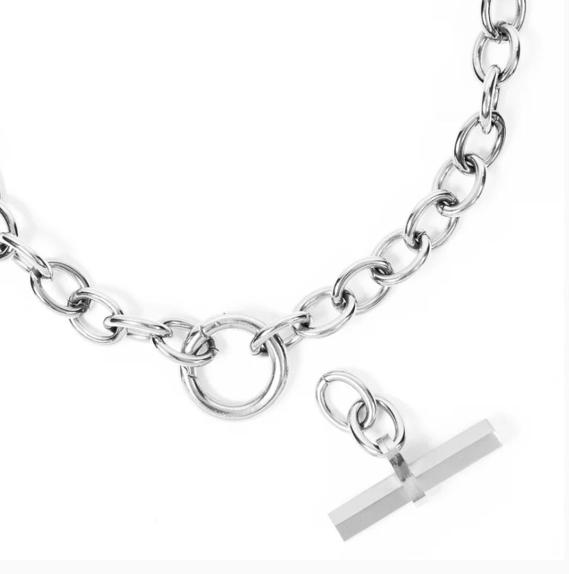 Silver chain necklace with a T-shaped pendant on a white background
