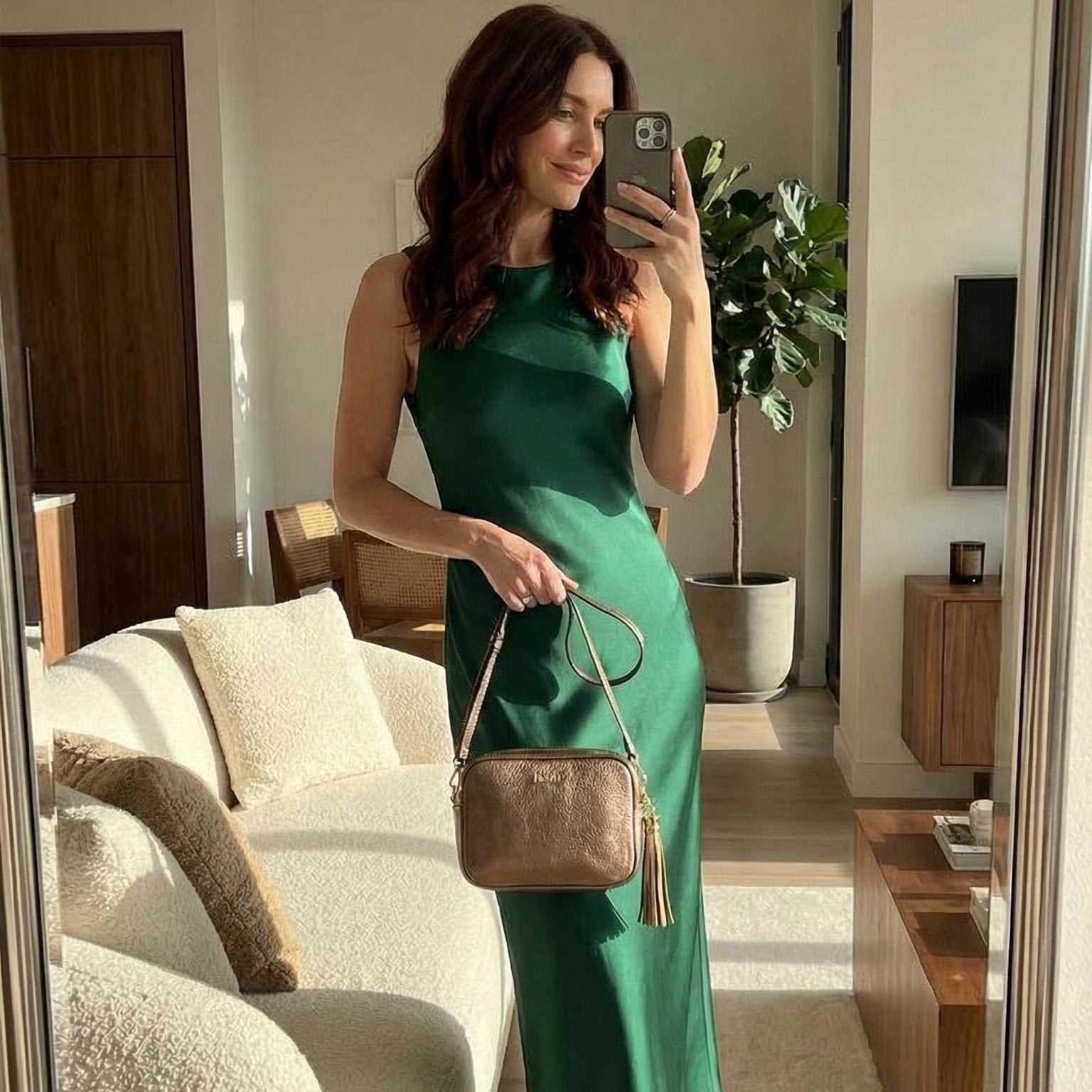 woman withh bronze evening bag taking selfie