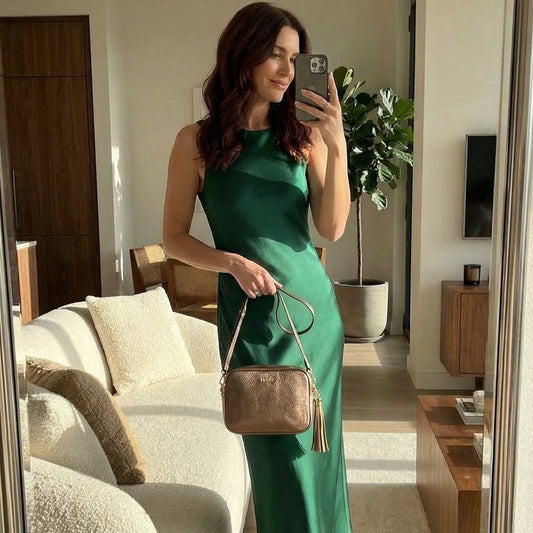 woman withh bronze evening bag taking selfie