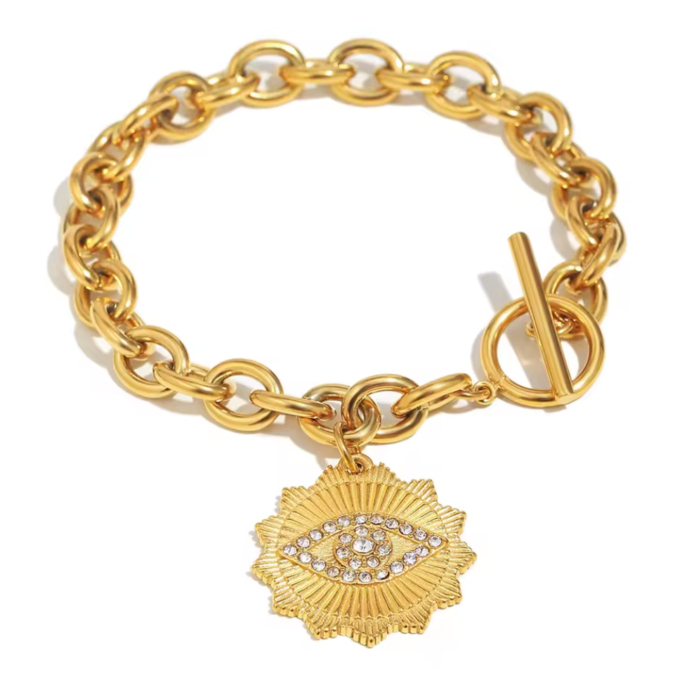 Gold chain bracelet with an eye-shaped charm on a white background