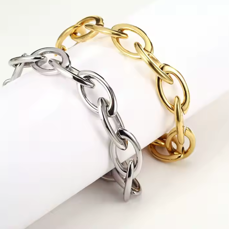 Two chain-link bracelets, one gold and one silver