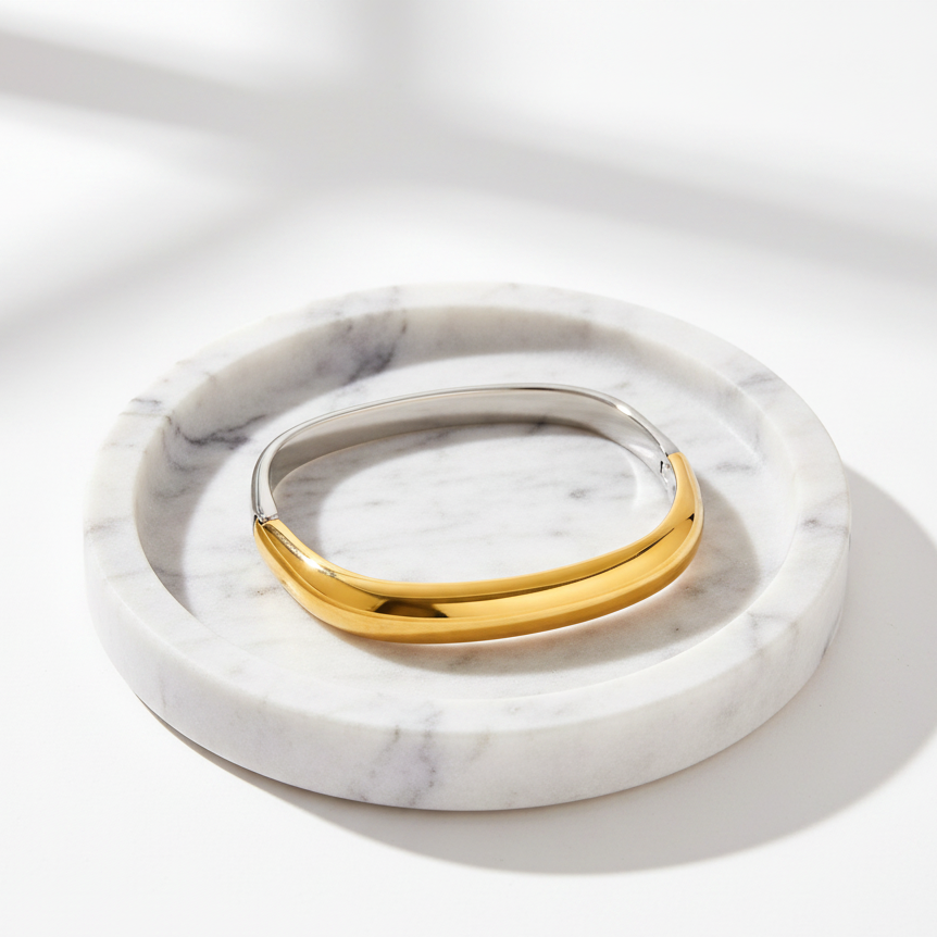 Gold & Silver bracelet on a marble surface