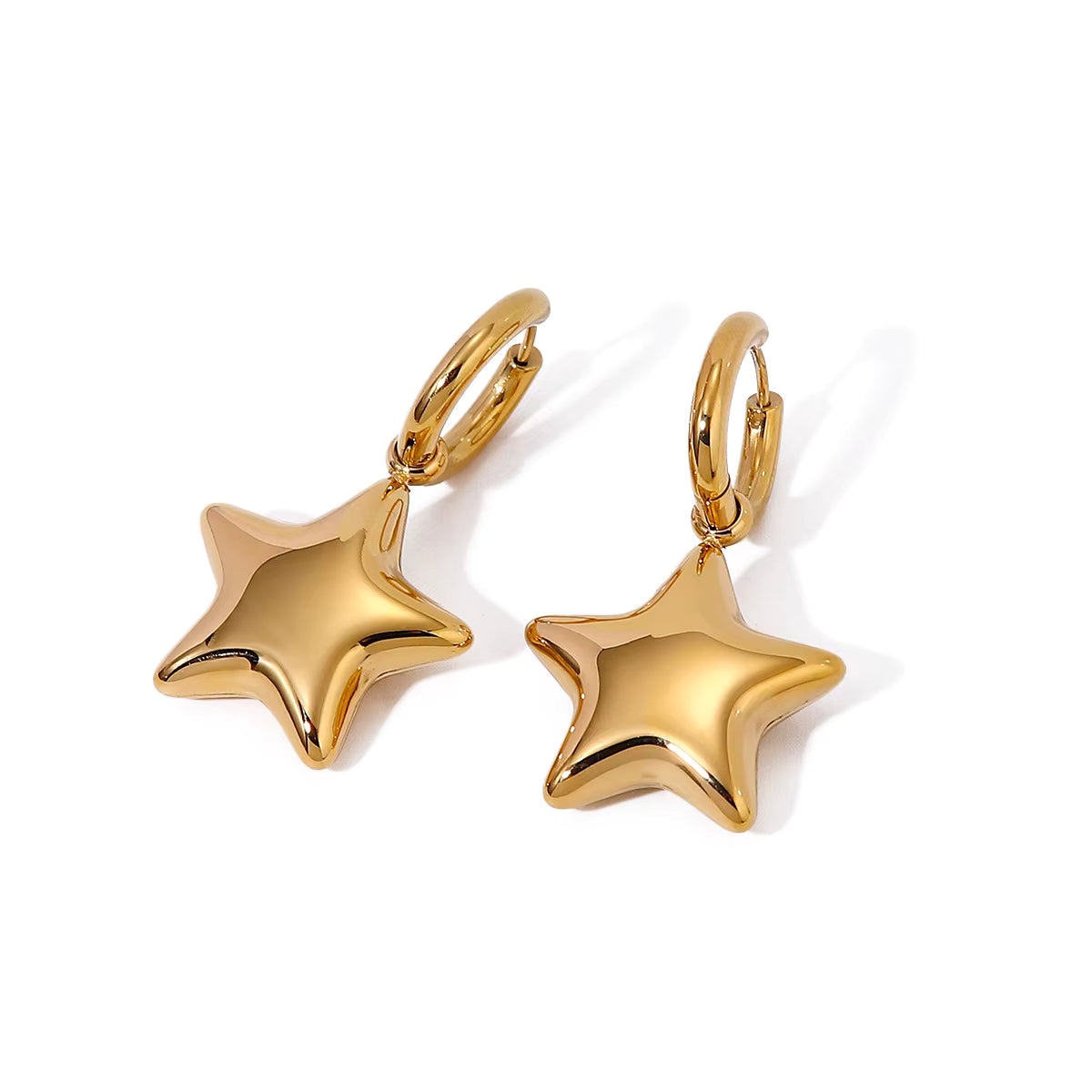 Gold star-shaped earrings on a white background