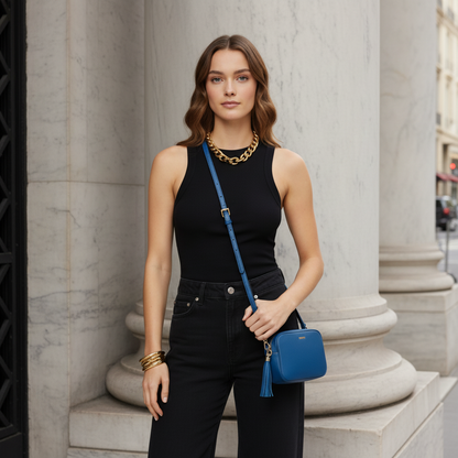 Blue handbag with a tassel on a white background